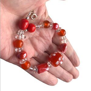 Orange bead bracelet w/white floral design